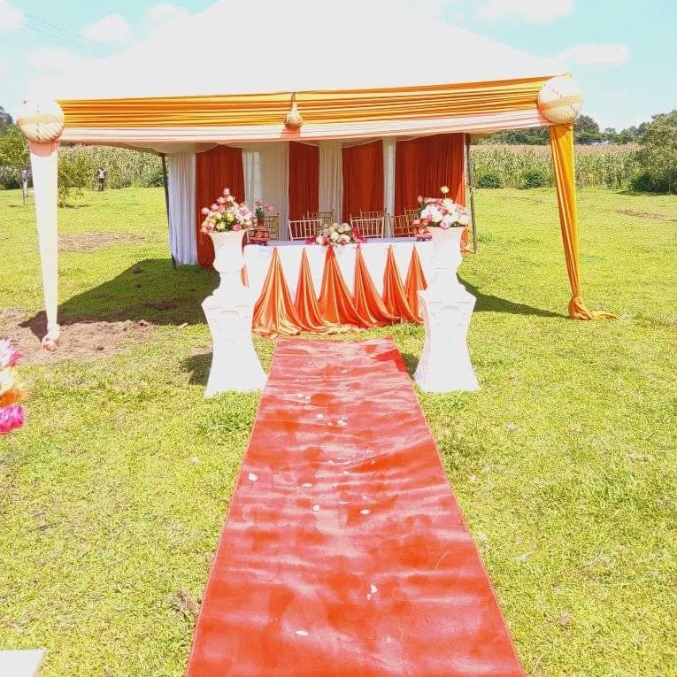 Large family celebratory dinner setup under pagoda tents